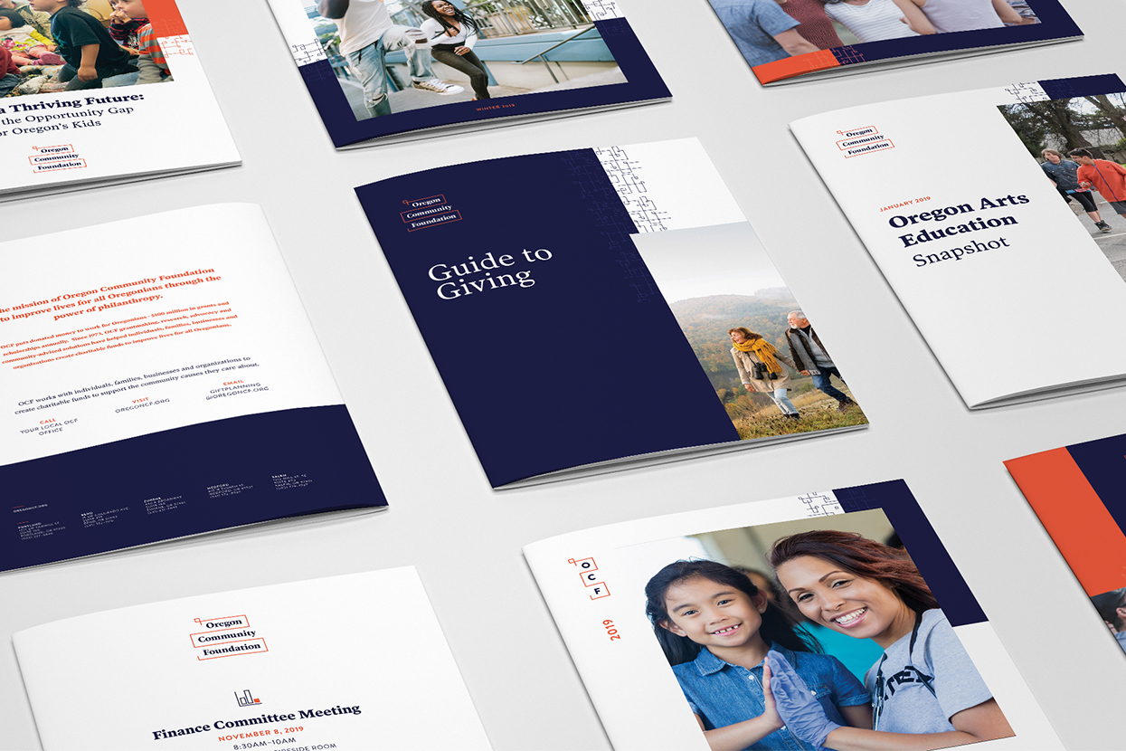 A photo of several Oregon Community Foundations annual reports laid out in grid format on a table