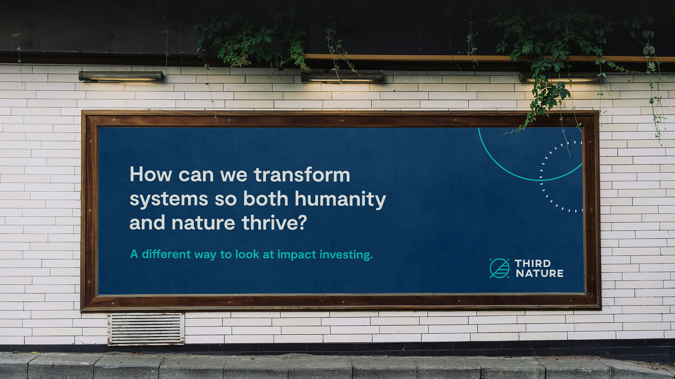 A billboard on a white tiled wall with green vines surrounding that reads "How can we transform systems so both humanity and nature thrive? A different way to look at impact investing. Third Nature"