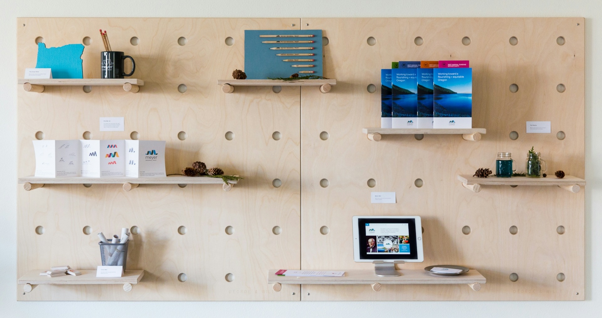 Large pegboard displaying Meyer Memorial Trust marketing materials.