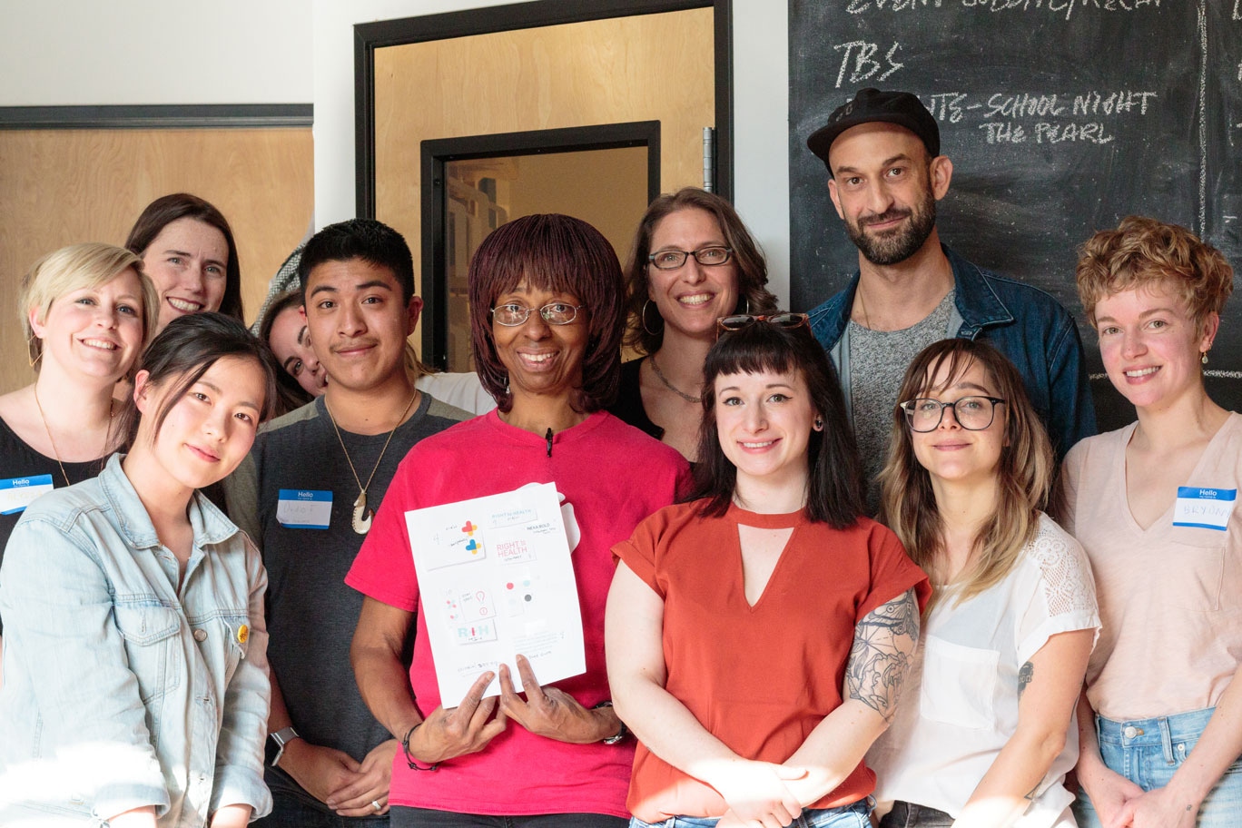 A group of people posing for picture at a design tournament.