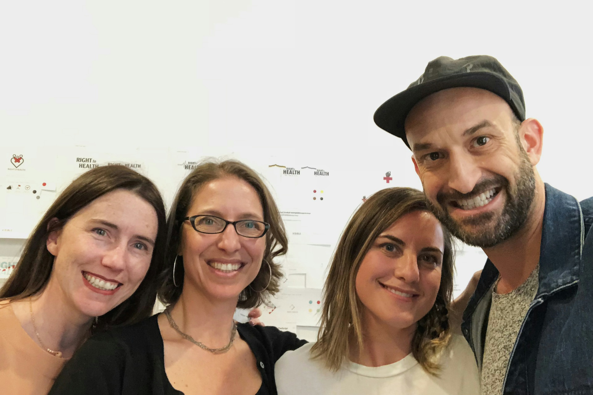 Four people posing for picture at a design tournament.