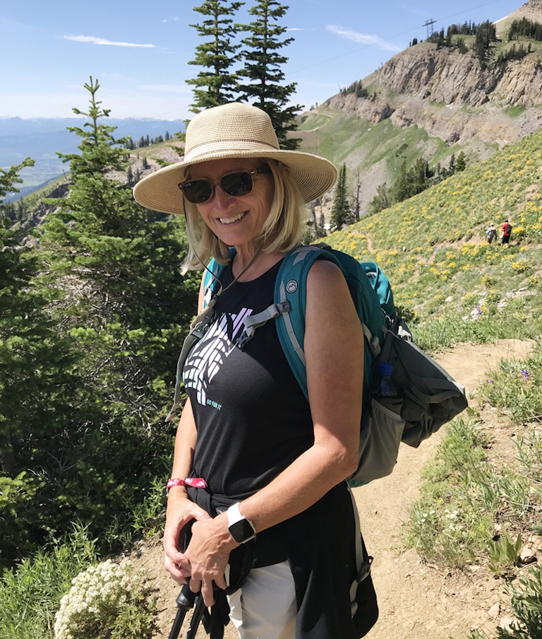 Debbie Potaniec hiking in the mountains. 