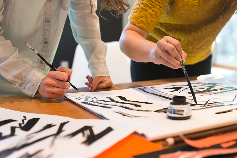 People painting a zebra painting.