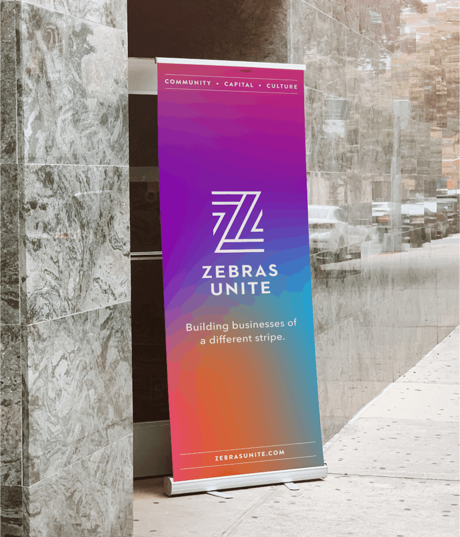 A roll-up banner with the Zebras Unite branding created to travel flexibly to any event put on by the organization.