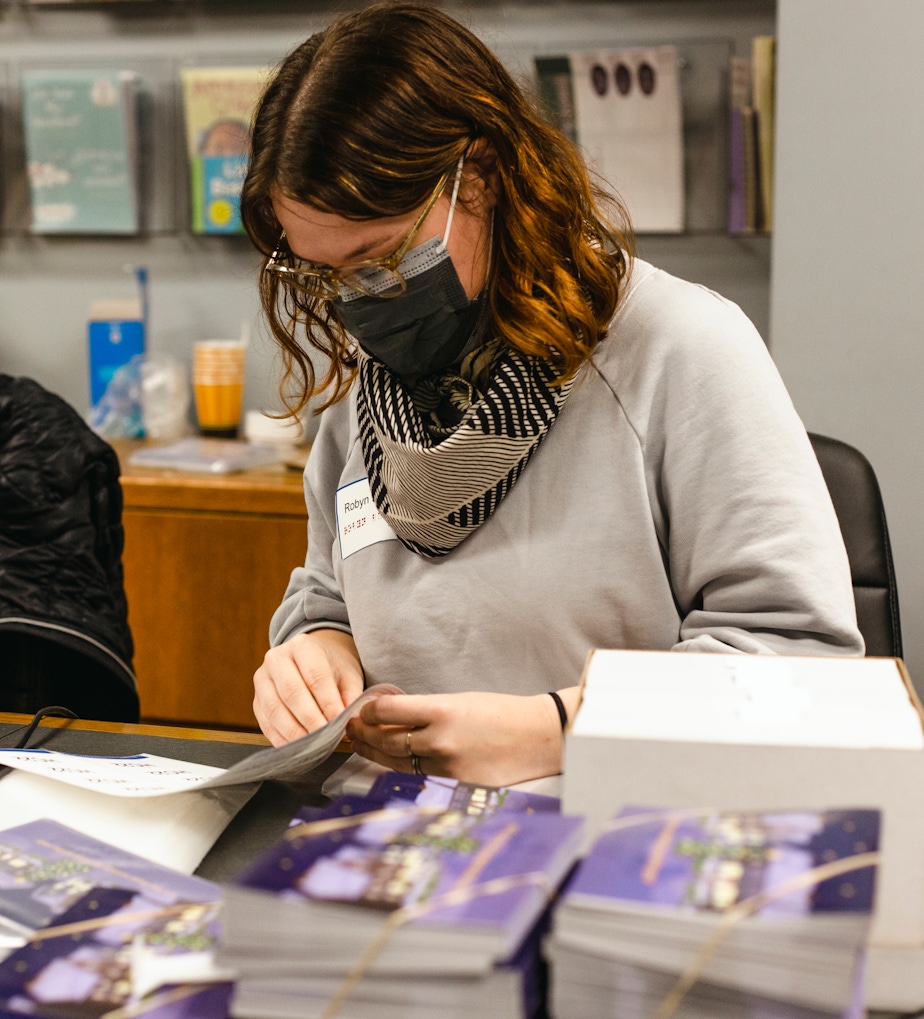 Robyn Baker volunteers at National Braille Press by putting together card kits for donors.