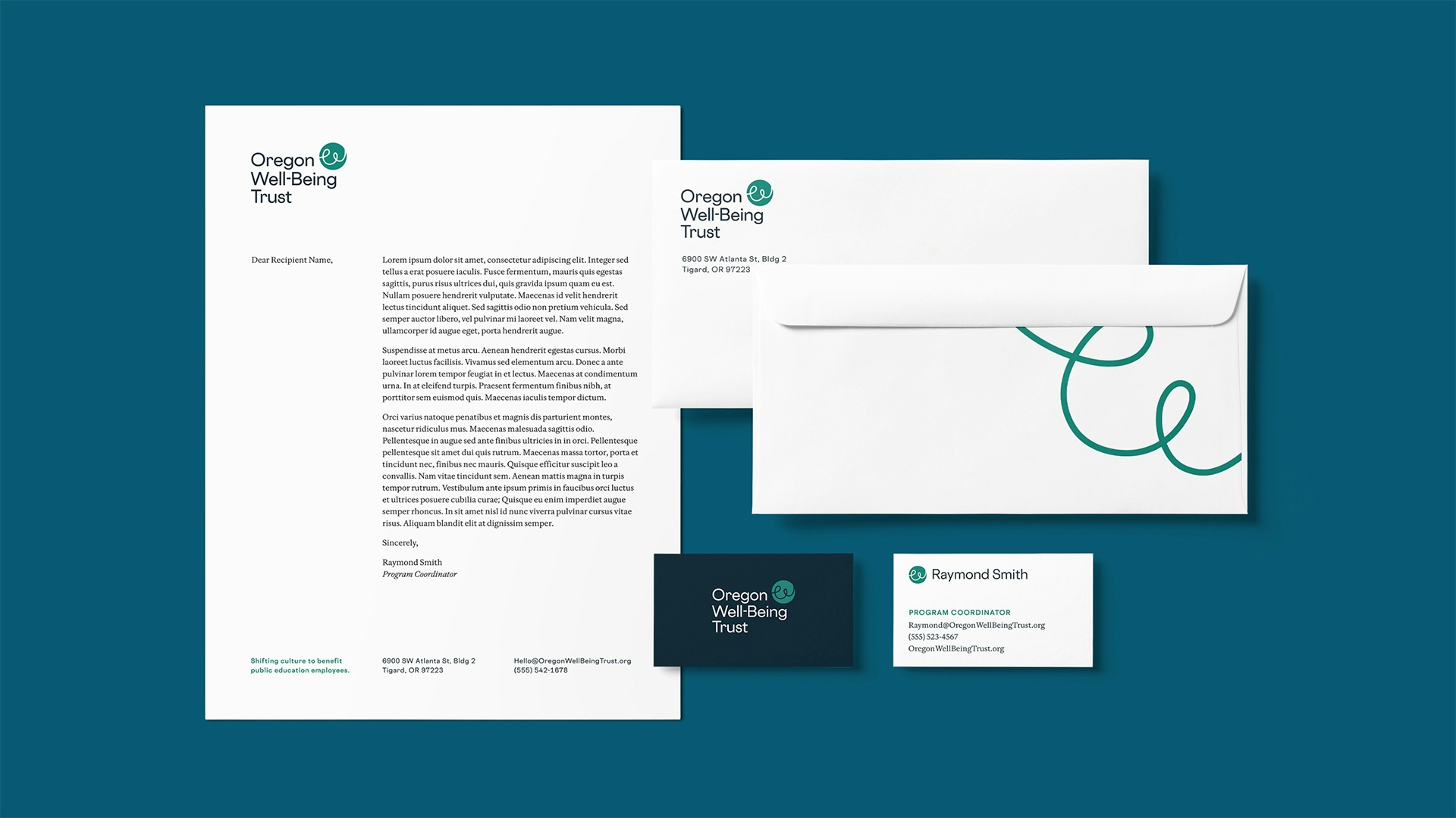 A flat lay of stationary designs that are simplistic and include the new OWT logo.