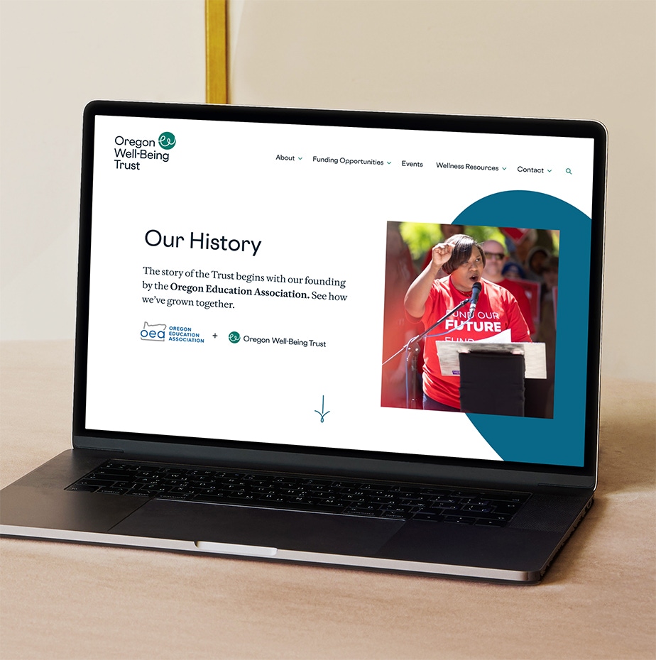 A photograph of the homepage of the new OWT website on an open laptop.