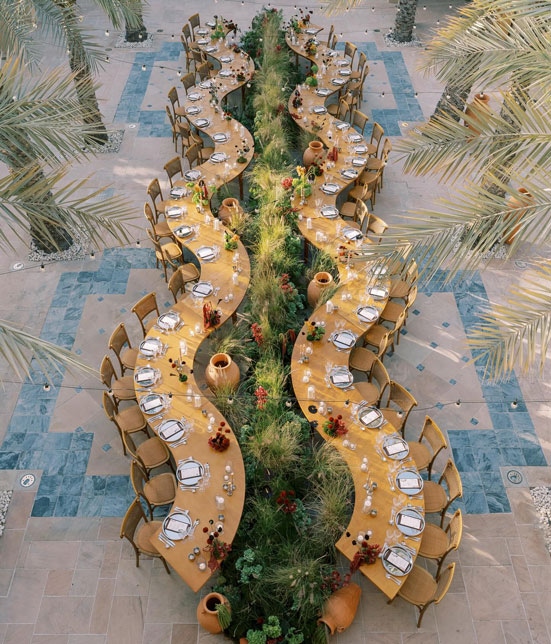 two parallel squiggly tables facing each other, where the diners would be looking at each other.
